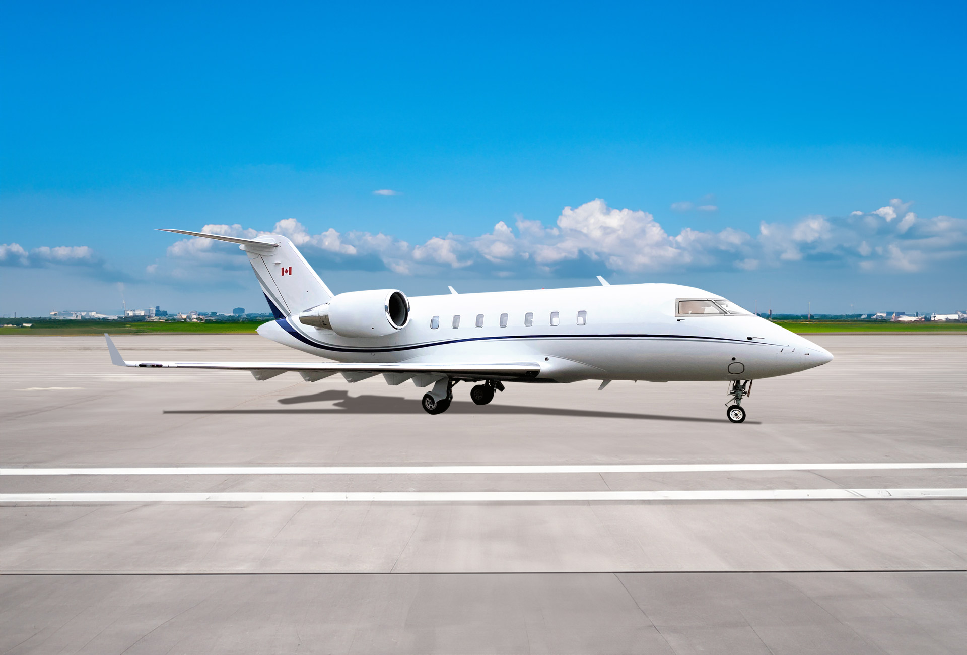 White Bombardier Challenger 605 with blue stripes.