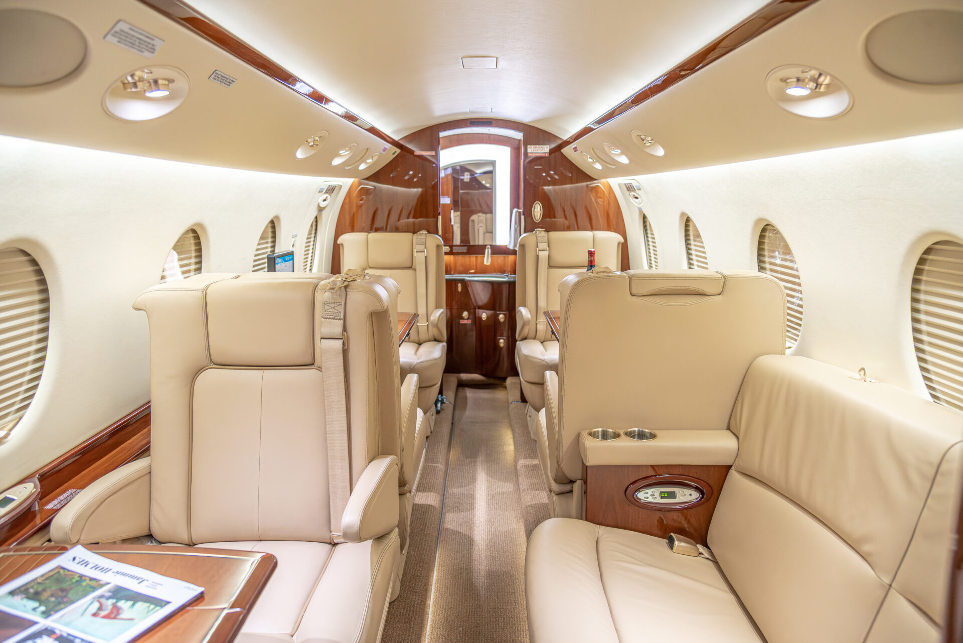 Gulfstream G150 cabin with beige leather seats, 8 passengers